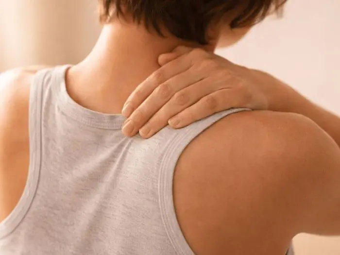 Close-up of a person receiving a gentle chiropractic neck and shoulder adjustment, representing chiropractic adjustments at Dr. Crystal's Chiropractic Care in Le Claire, Iowa