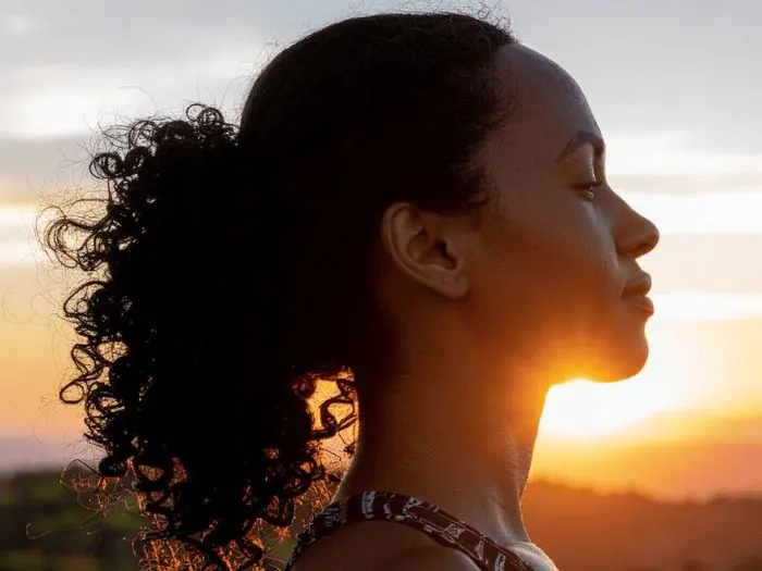 Person breathing in fresh air and watching the sunset, representing whole-person lifestyle advice and wellness coaching at Dr. Crystal's Chiropractic Care