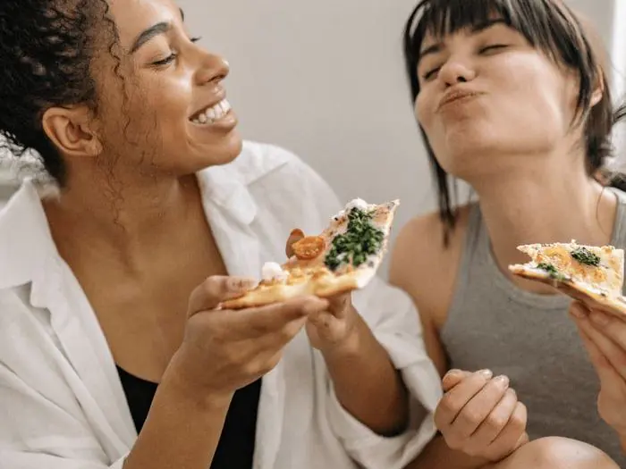 Two friends enjoying a healthy meal together, representing nutritional consultations at Dr. Crystal's Chiropractic Care in Le Claire, Iowa